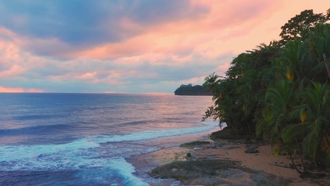 Sunrise over tropical island beach and palm tree, costa rica, pink sunrise. High quality 4k footage