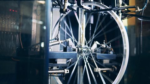 Bicycle wheel truing machine at a bicycle factory