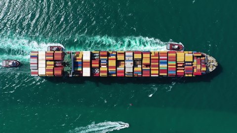 Large Container Ship in Sea. Aerial Top-Down View. Drone Flies Sideways.