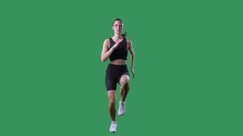 Slow motion of fit woman doing high knee exercise front view. Full body on chroma key green screen. 