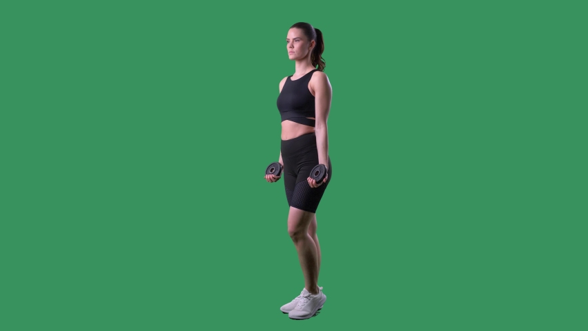 Young fit woman doing standing biceps weight lifting exercises. Full body on chroma key green screen.  Royalty-Free Stock Footage #1067773958