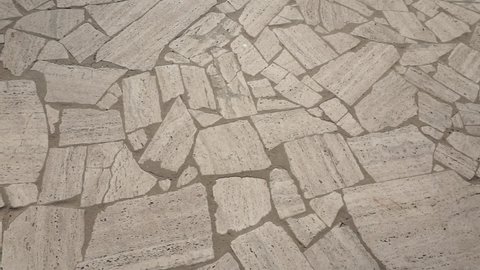 Detail of an outdoor Roman travertine flooring laid in opus incertum.