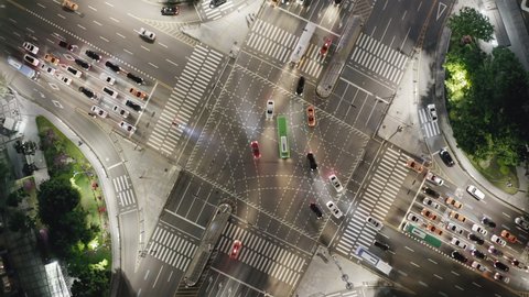 Beautiful aerial view of a crossroad in Seoul Gangnam District on the evening, surrounded by modern skyscrapers. Road surface marking text is written in Korean language.