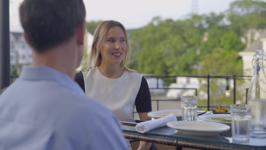 Young Caucasian Couple Talking and Laughing at an Outdoor Restaurant in Roslyn