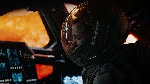 Portrait of Caucasian male astronaut inside spaceship cockpit. Sci-fi space exploration concept. Mars mission. Shot with 2x Anamorphic lens