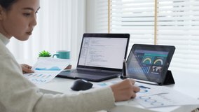 Back rear view of young asian woman, freelance data scientist work remotely at home coding programing on Big data mining, AI data engineering, IT Technician Works on Artificial Intelligence Project. - Powered by Shutterstock - Get 15% off with code: PIKWIZARD15