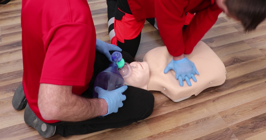 First aid training. Two medics train on courses. Reanimation with artificial ventilation . First Aid Cardiopulmonary Resuscitation, How to do the CPR Royalty-Free Stock Footage #1067807276