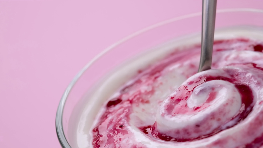 Yogurt with berry jam in spoon, curd cream swirl with fruit topping, blueberry whipped cream, ProRes uncompressed video | Shutterstock HD Video #1067807813