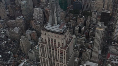 Close up view circling the top of the Empire State Building with a view of the office buildings in the background, Manhattan, New York City in 2019