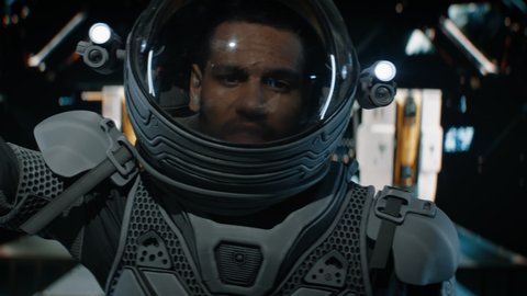 POV Black African American male astronaut having remote video call inside spaceship cockpit. Sci-fi space exploration concept. Shot with 2x Anamorphic lens