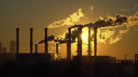 industrial landscape, the pipes of the thermal power plant at sunset