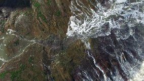 Aerial Drone footage of Waves Rushing Rocks