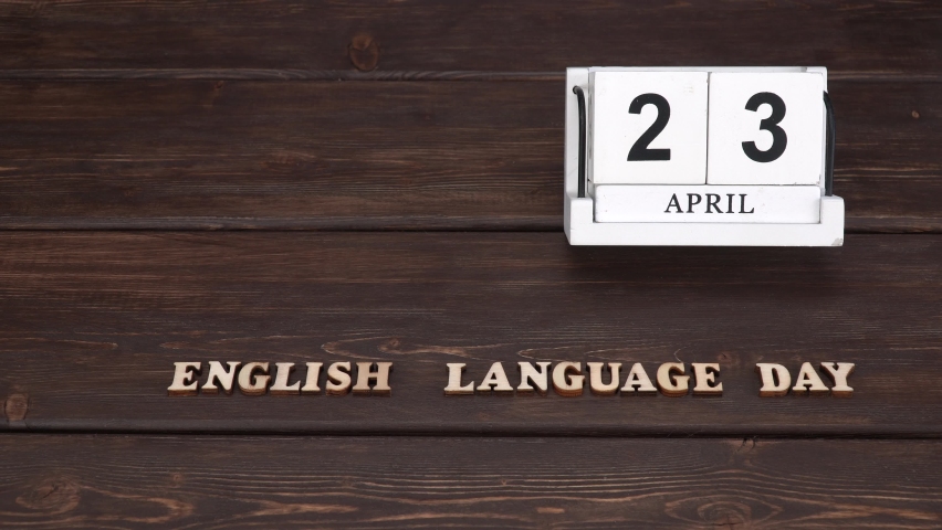 April 23, date on the calendar.  English Language Day. Handmade wood cube with date month and day. Wooden letters on wooden background. english alphabet. 