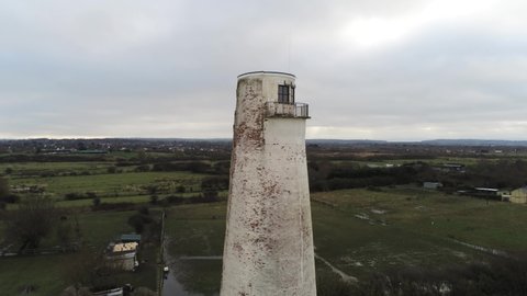 Historic Leasowe Lighthouse maritime beacon landmark aerial coastal countryside Wirral view close rising to birdseye