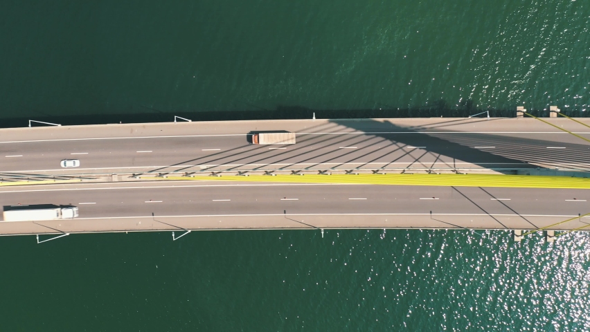 Bridge above the ocean aerial top down view of the traffic, located in Laguna, Santa Catarina, Brazil