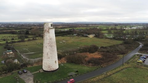 Historic Leasowe Lighthouse maritime beacon landmark aerial coastal countryside Wirral view slow pull away