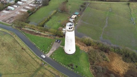 Historic Leasowe Lighthouse maritime beacon landmark aerial coastal countryside Wirral high descend tilting up view