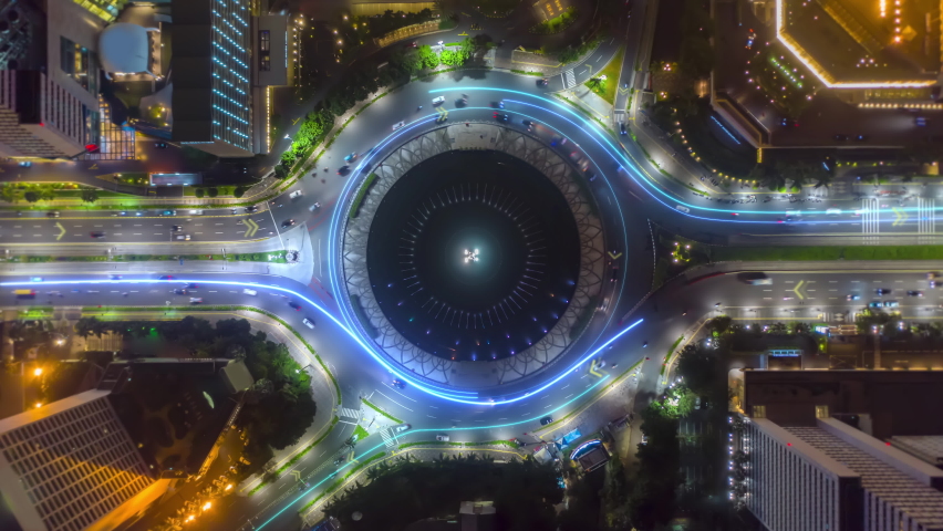 Aerial hyperlapse shot of traffic in a city Roundabout, with light trails - 3d graphics animation - top down drone view | Shutterstock HD Video #1067827166