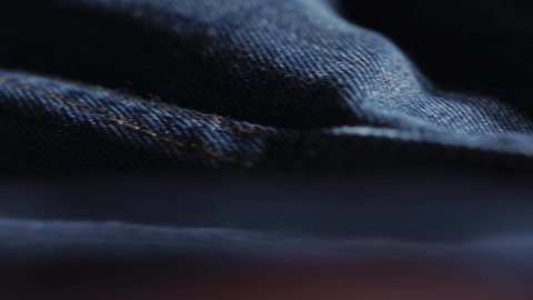 Panning Shot Of Denim Jeans During Manufacturing In A Sweatshop, Indigo Blue Fabric