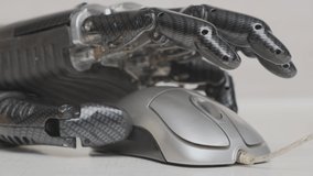 Man with bionic prosthetic hand working on laptop or computer, close-up finger of artificial hand pressing mouse button. - Powered by Shutterstock - Get 15% off with code: PIKWIZARD15
