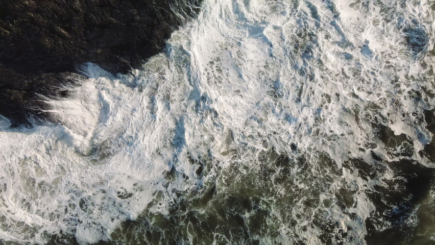 Amazing Aerial View of Big King Tide Waves Crashing Washington Coast Rocky Shore, Drone top view of big waves slamming into the rocks of Cape Disappointment