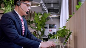 Businessman wearing telephone headset talking to caller in customer services department. Male professional call center agent, having distance webcam chat job interview on computer at home office.
 - Powered by Shutterstock - Get 15% off with code: PIKWIZARD15