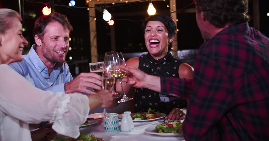 Group Of Mature Friends Enjoying Meal At Rooftop Restaurant Royalty-Free Stock Footage #10678409