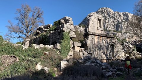 Antalya, Turkey - February 5 2021: Ancient buldings of Turkish hammam ruins at Termessos ancient mountain city in the forests of Antalya. Rocks of ancient city during the day in sunlight