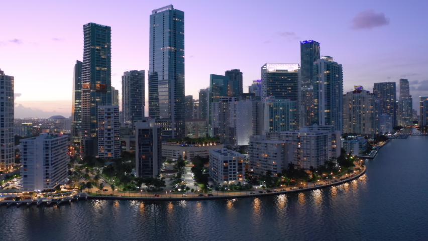 Waterfront city at night. Aerial view of downtown Miami, Florida, USA 4K. Downtown scene cityscape at sunset. Landmark of Miami City. Night city life. Nightlife urban downtown view. Modern skyscrapers