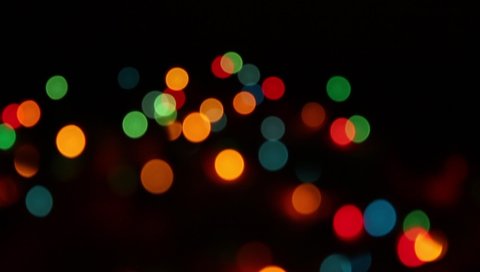 Abstract bokeh lights background. Bokeh effect for your video transitions. Colorful soft focus lights in darkness.