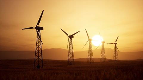 Beautiful 3D animation of several wind turbines at sunset in a field with beautiful mountain views.3D render. Adlı Stok Video