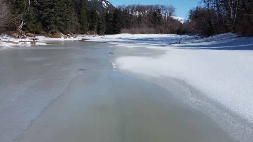 Flight over a frozen creek spring 2021