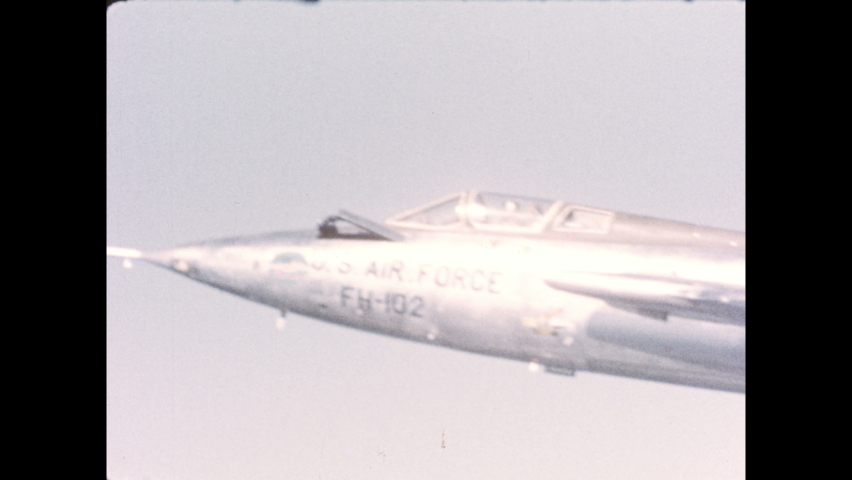 1970s: U.S. Air Force FH-102 aircraft flies left through the open sky.