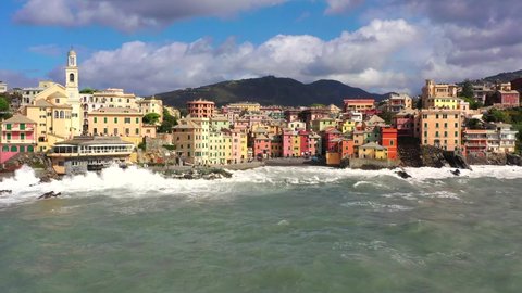 Boccadasse in Liguria with the stormy sea. Aerial view with drone of the characteristic seaside village. Genoa. 