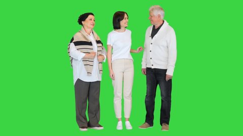 Attractive young woman having fun with happy older parents on a Green Screen, Chroma Key.