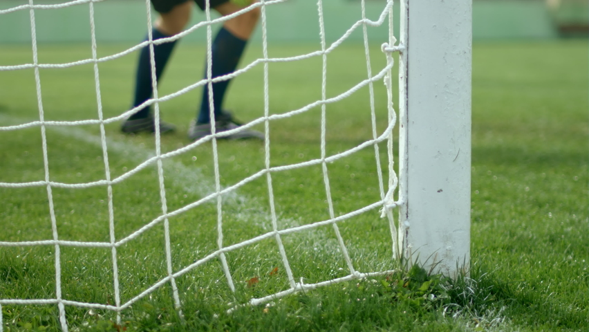 Football soccer game. Detail shot of a goal. Goalkeeper jumping for the ball, but missing to save the door, 4k slow motion | Shutterstock HD Video #1067880059