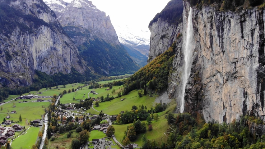 Aerial view over the village of Lauterbrunnen in Switzerlandwith its famous waterfall - drone footage Royalty-Free Stock Footage #1067890457