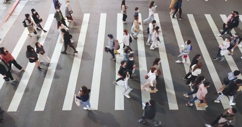 Taipei, Taiwan - February 7, 2021 : Top view of people are walking on pedestrian crosswalk or zebra crossing