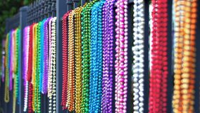 Colorful Mardi Gras Beads Hanging on Iron Fence New Orleans - Powered by Shutterstock - Get 15% off with code: PIKWIZARD15