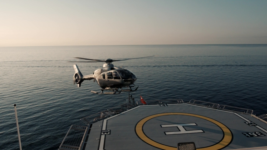 Jet helicopter landing on large super yacht heli deck at sea. Filmed in 200fps for excellent cinematic slow motion. Royalty-Free Stock Footage #1067892536