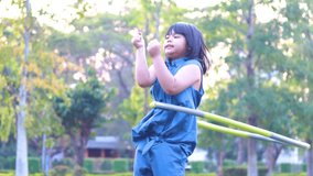 Girl playing Hula hoop in the grass - Powered by Shutterstock - Get 15% off with code: PIKWIZARD15
