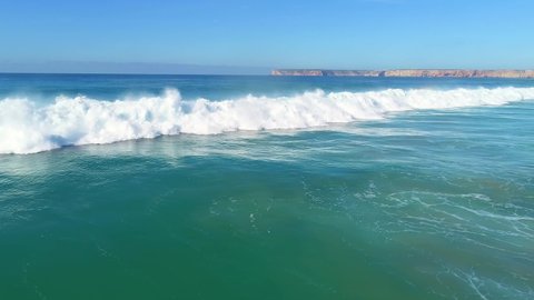 wave rushes to the coast in Sagres, Tracking shot Aerial view
