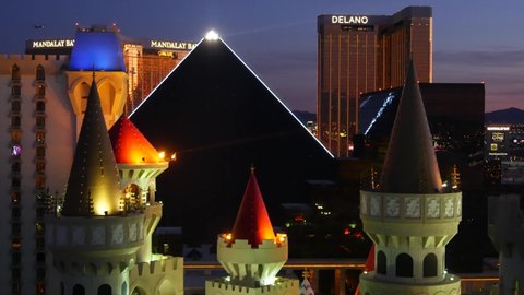 LAS VEGAS, NEVADA USA - 4 MAR 2020: Excalibur castle and Luxor pyramid casino uncommon aerial view. Plane flying from McCarran airport. Mandalay Bay and Delano hotel in american gambling sin city.