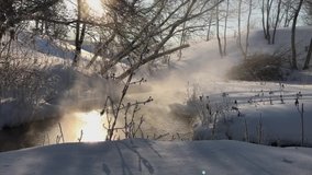 frost and sun, a wonderful day. view of the vapors over the river on a winter morning with the sun shining through the branches in the village. - Powered by Shutterstock - Get 15% off with code: PIKWIZARD15