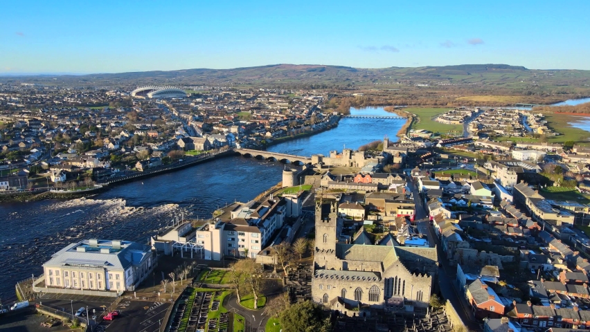 Aerial view over Limerick City in Republic of Ireland. There are number of eye-catching landmarks in Limerick such as Thomond Bridge, King John's Castle, St. Mary's Cathedral and River Shannon. Royalty-Free Stock Footage #1067910095