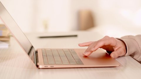cropped view of woman using touchpad on laptop
