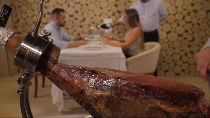 Iberian ham cutter master cutting a piece. | Shutterstock HD Video #1067916827