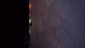 The Milky Way over the Horizon and an Island (Vertical, Time Lapse, Panning)