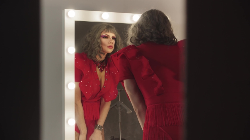 A young man drag artist preening up in front of the mirror Royalty-Free Stock Footage #1067932058