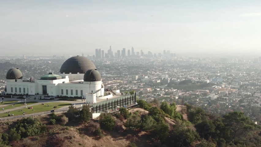 LOS ANGELES, CA, USA - Feb 15, 2021: Aerial drone view of Griffith Park observatory, downtown Los Angeles skyline. California travel destination in America. 